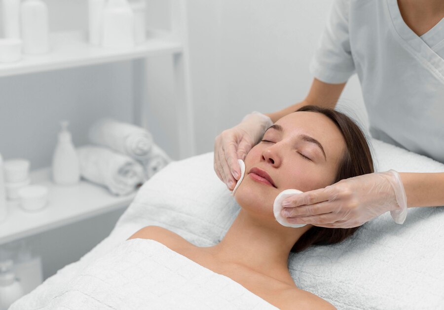 beautician with female client salon face care routine_23 2148875460