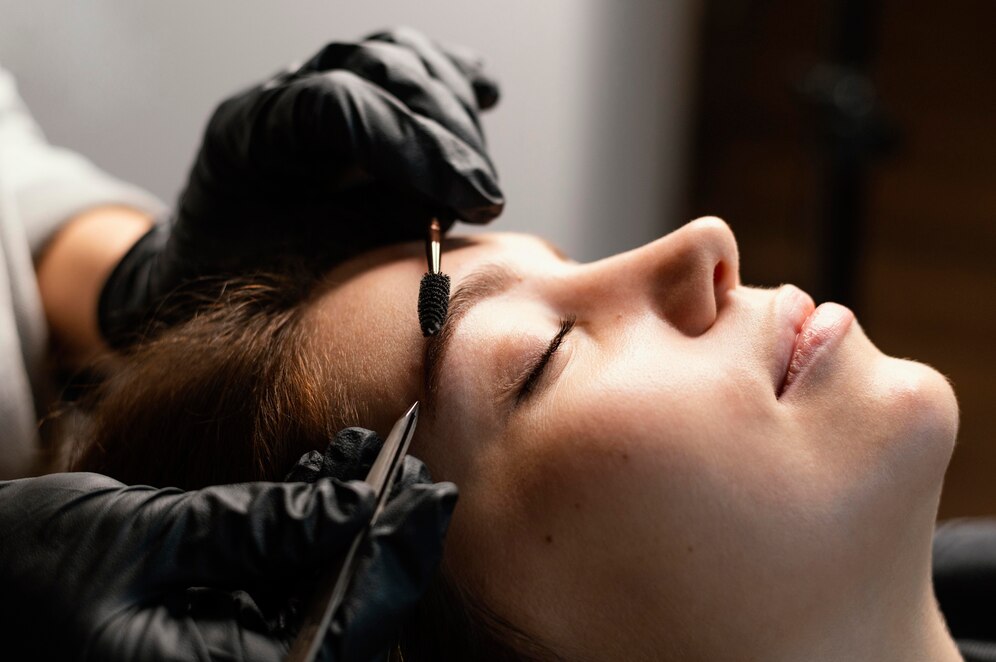 side view female specialist doing eyebrow treatment woman_23 2148846011
